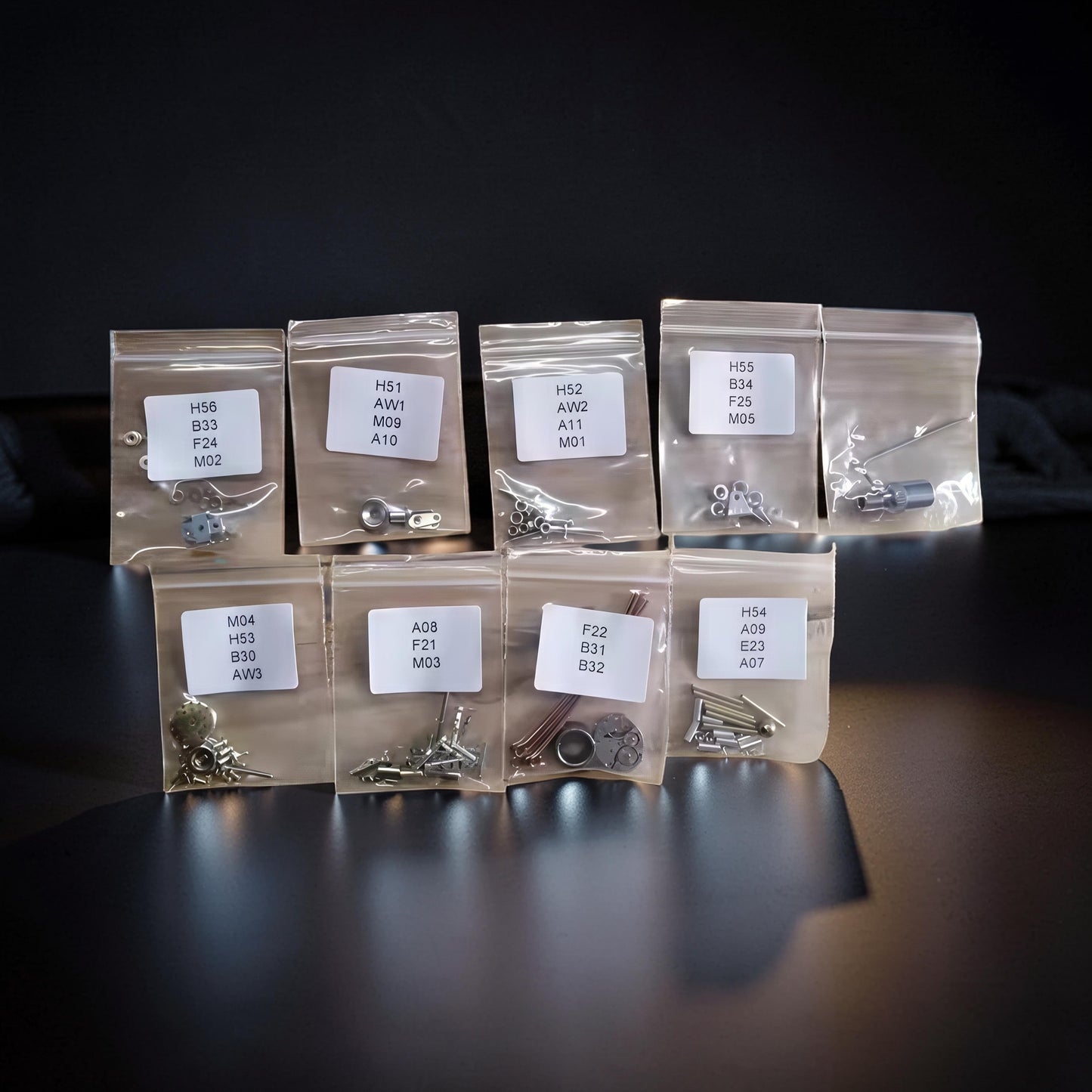 The Curious Mind Spider DIY Kit - Style A metal parts organized in labeled bags for assembly.