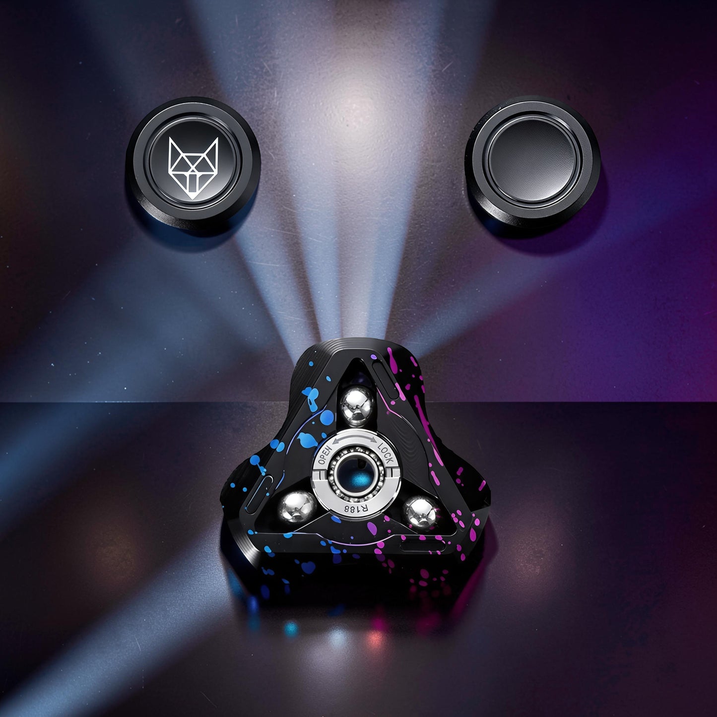 The Curious Mind Spirit Fox Glow Spinner with black, blue, and pink splatter design. Features metal construction and light-up detailing.