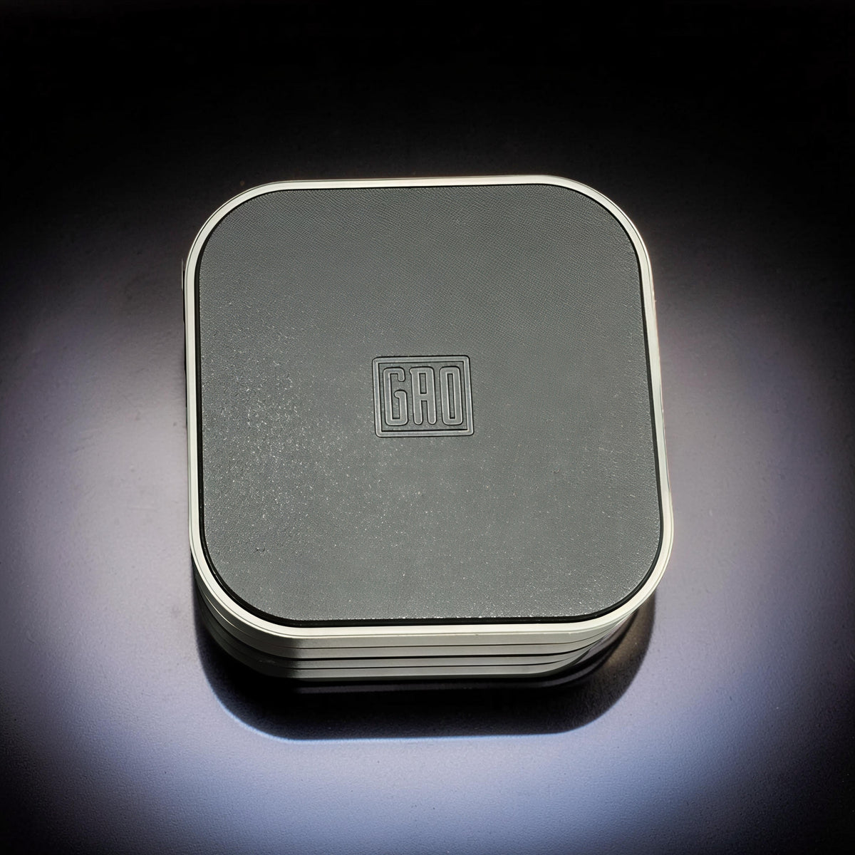 The Curious Mind Tetris Stainless Steel Slider fidget toy with a dark grey textured top and silver trim.