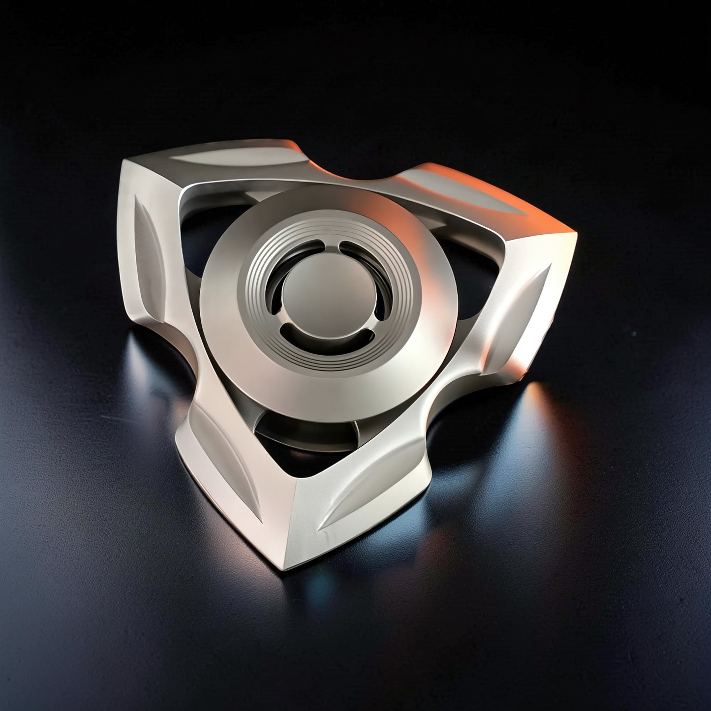 The Curious Mind stainless steel tri-blade spinner with a futuristic, angular design. Metallic silver finish.
