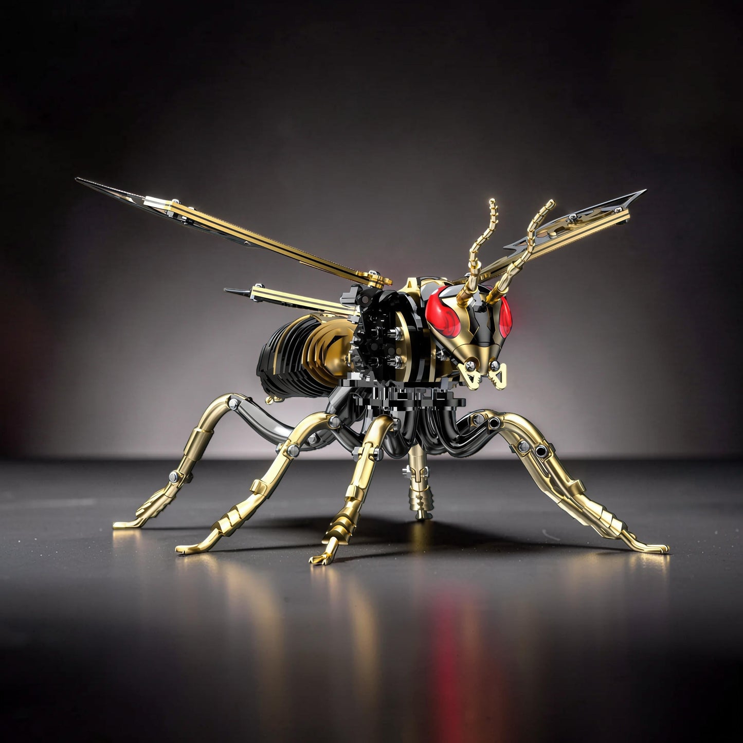 The Curious Mind Stainless Wasp 3D metal model kit with gold and silver accents, red eyes, and intricate mechanical details.