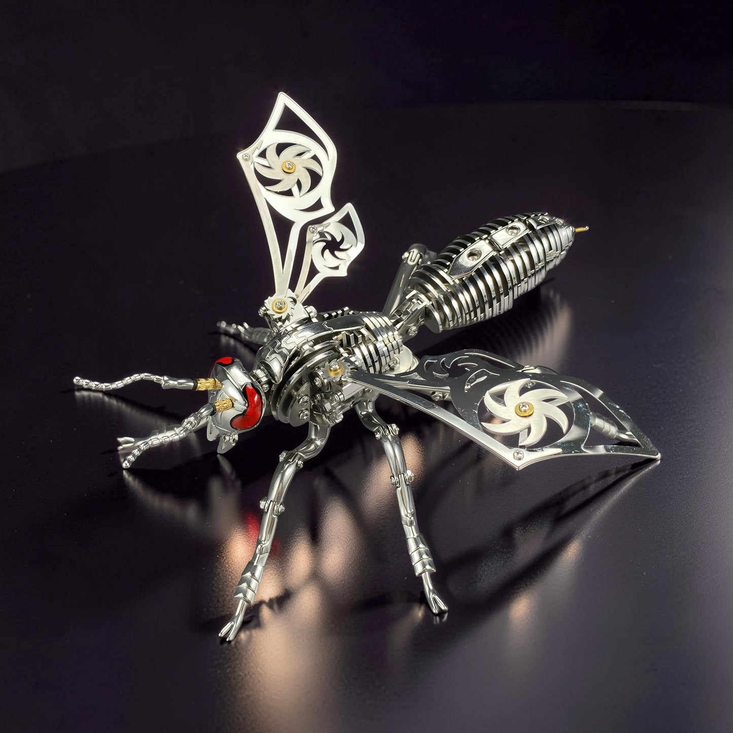 The Curious Mind Stainless Wasp 3D metal model kit, silver and gold finish, intricate mechanical design with red eyes.