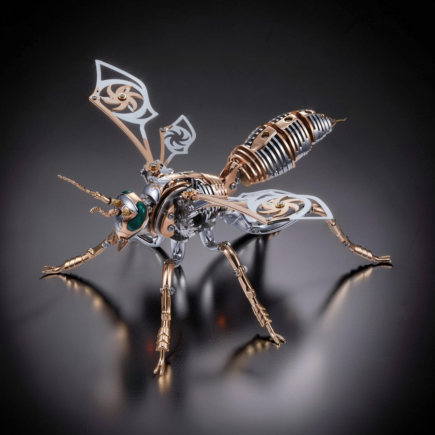 The Curious Mind Stainless Wasp 3D metal model kit with intricate silver and gold mechanical details and green eyes.