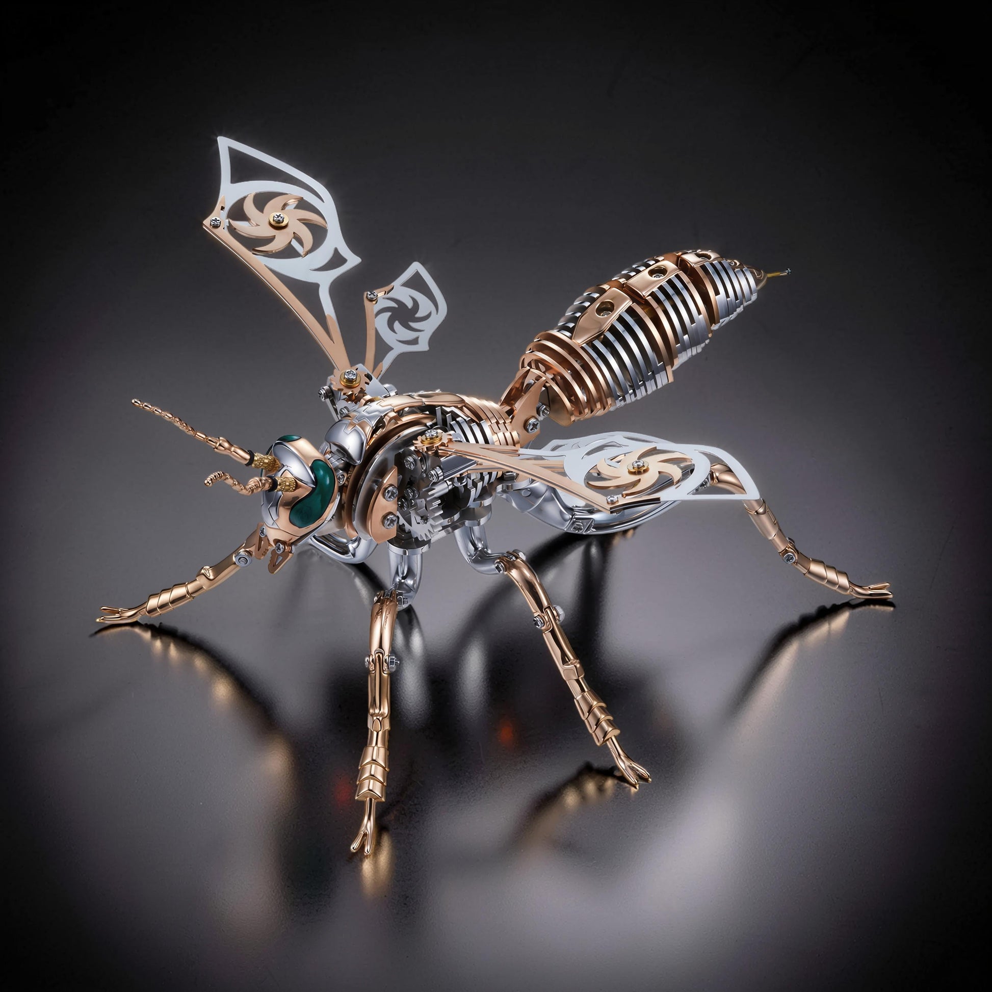 The Curious Mind Stainless Wasp 3D metal model kit with intricate silver and gold mechanical details and green eyes.