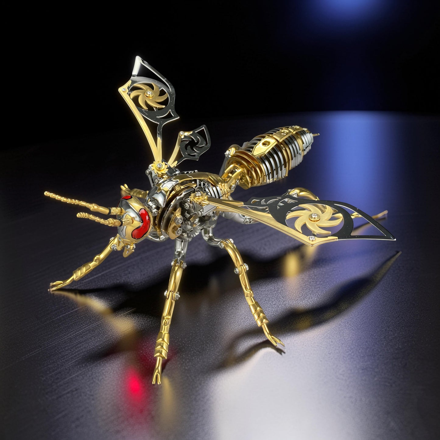 The Curious Mind Stainless Wasp 3D metal model kit, gold and silver finish, intricate mechanical design with red eyes.