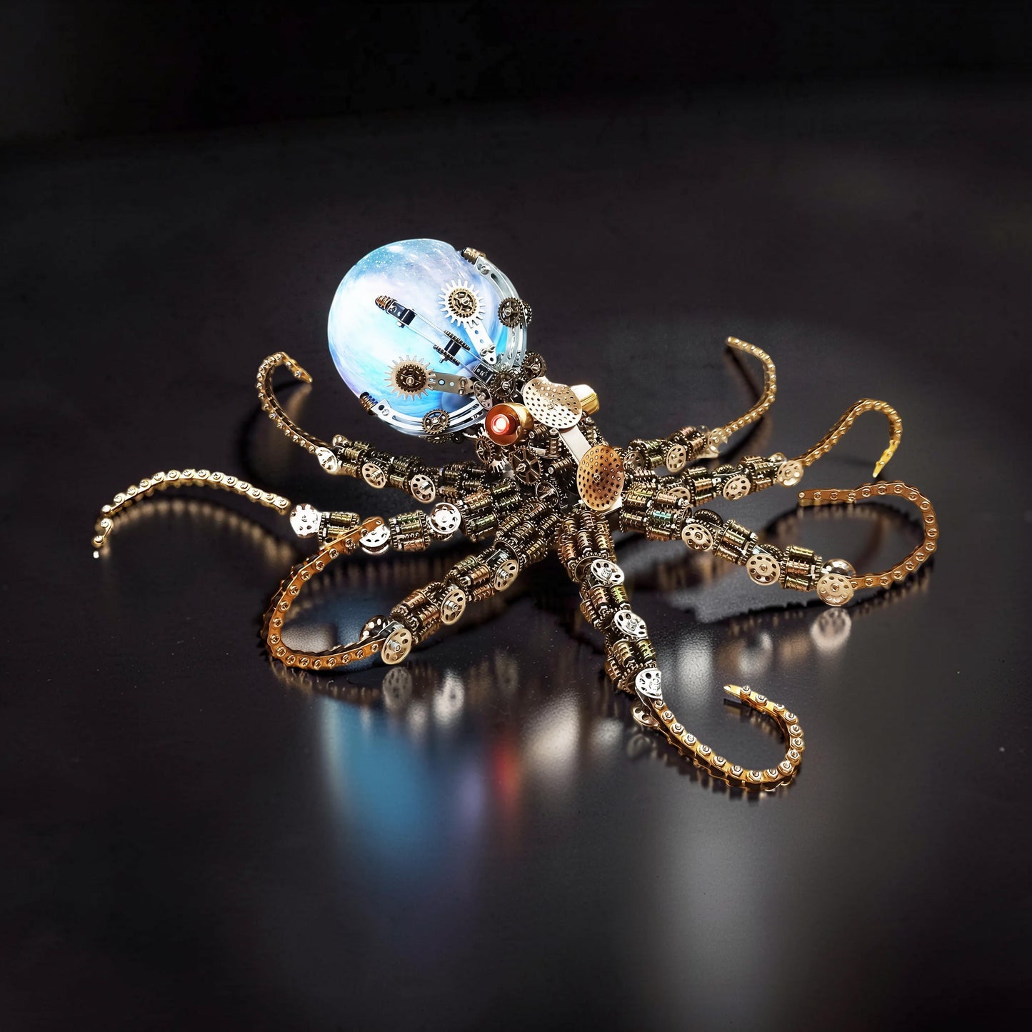 The Curious Mind Steampunk Octopus metal model kit with colourful lights and intricate gears. A detailed, 3D mechanical creature with a glowing blue orb head.
