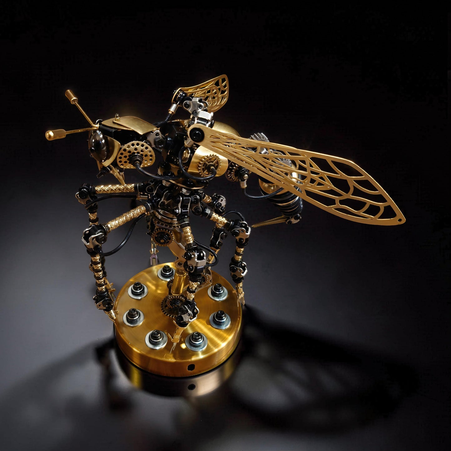 The Curious Mind Wasp with Voice-Activated Light, a steampunk metal model kit with intricate gears, gold wings, and LED lights on a brass base.