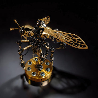 The Curious Mind Wasp with Voice-Activated Light, a steampunk metal model kit with intricate gears, gold wings, and LED lights on a brass base.