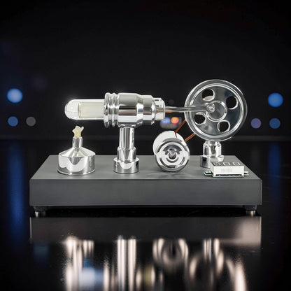 The Curious Mind mirror-polished metal Stirling engine model with voltmeter and USB port, featuring a glass cylinder and flywheel.