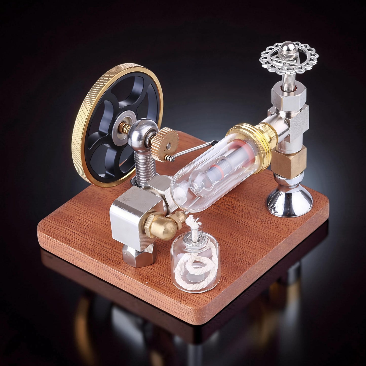 The Curious Mind Stirling Engine with adjustable speed controller, made from metal, wood, and glass. Features a flywheel, cylinder, and decorative valve.