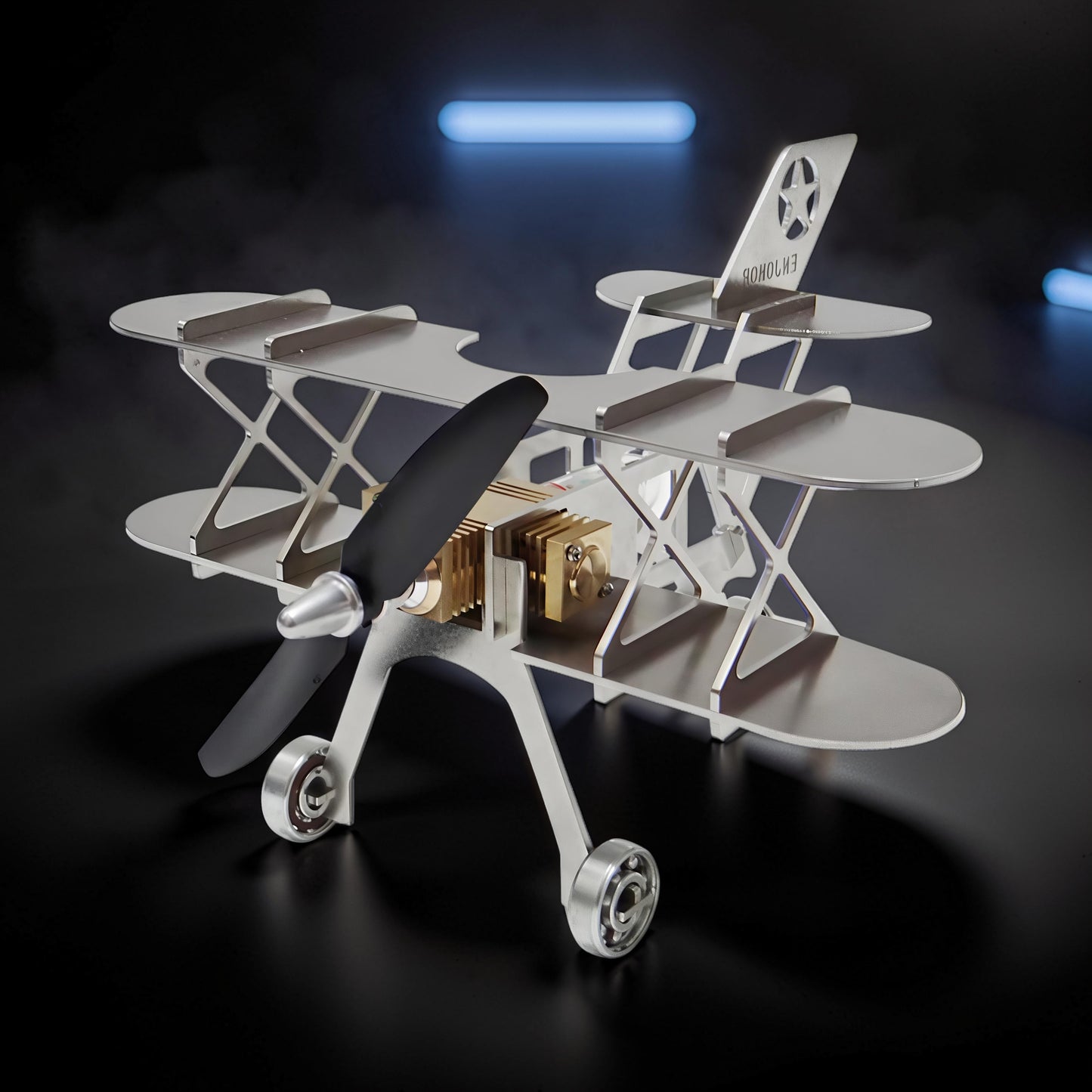 The Curious Mind Stirling Engine Model Aircraft, a silver metal biplane with a black propeller and gold engine details. Features a star emblem on the tail.
