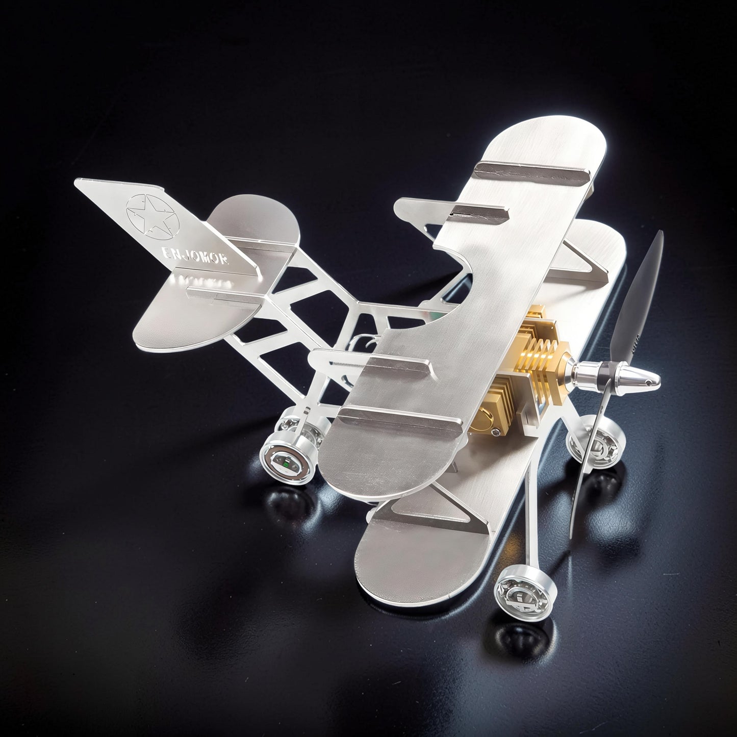 The Curious Mind Stirling Engine Model Aircraft, a metal biplane with a visible engine and propeller, perfect for desk display.