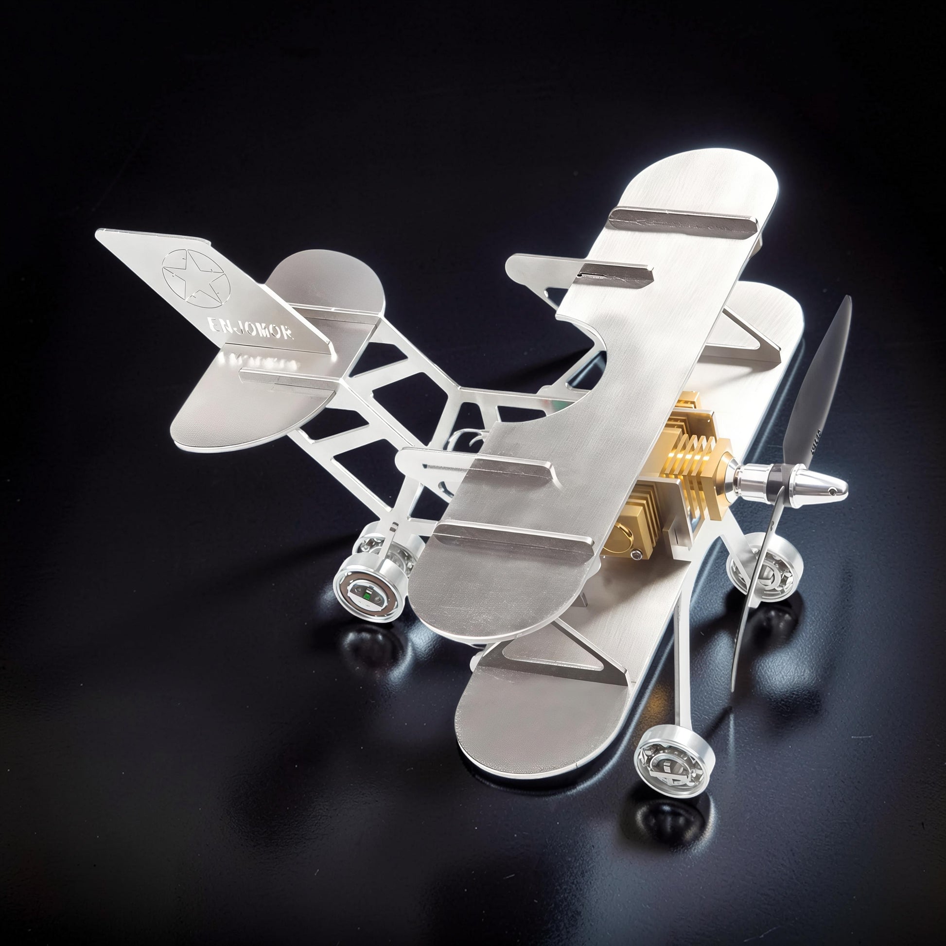 The Curious Mind Stirling Engine Model Aircraft, a metal biplane with a visible engine and propeller, perfect for desk display.