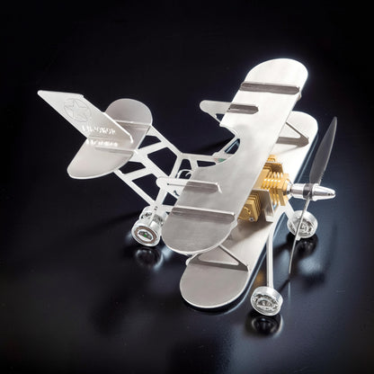 The Curious Mind Stirling Engine Model Aircraft, a metal biplane with a visible engine and propeller, perfect for desk display.