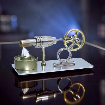 The Curious Mind Classic Stirling Engine Display with gold flywheel and metal construction, on a reflective surface.