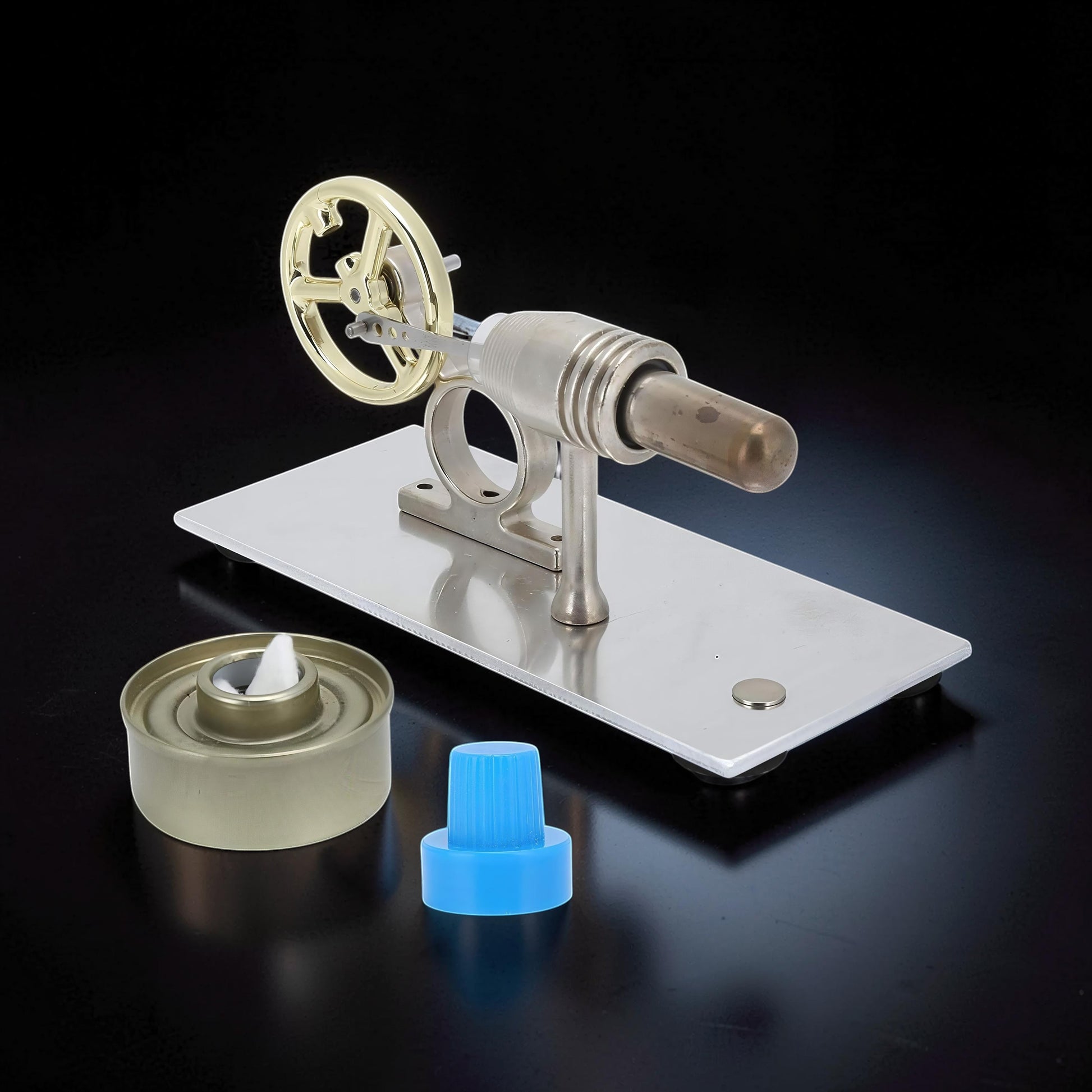 The Curious Mind Classic Stirling Engine Display, a metal mechanical model with a gold flywheel and a fuel wick.