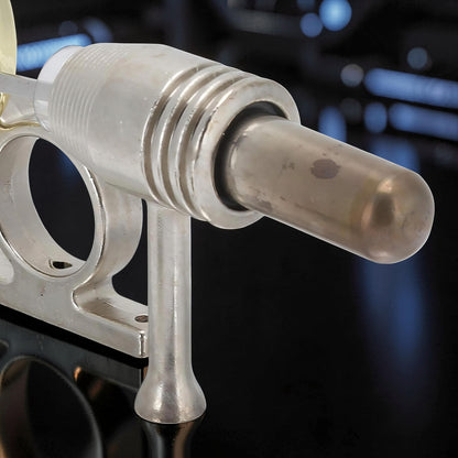 The Curious Mind Classic Stirling Engine Display mechanical model, made of polished metal with a clear cylinder and ribbed housing.