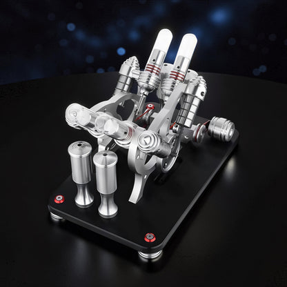 The Curious Mind Stirling Engine V4 Display Model, a metal mechanical model with dual cylinders and intricate moving parts on a black base.