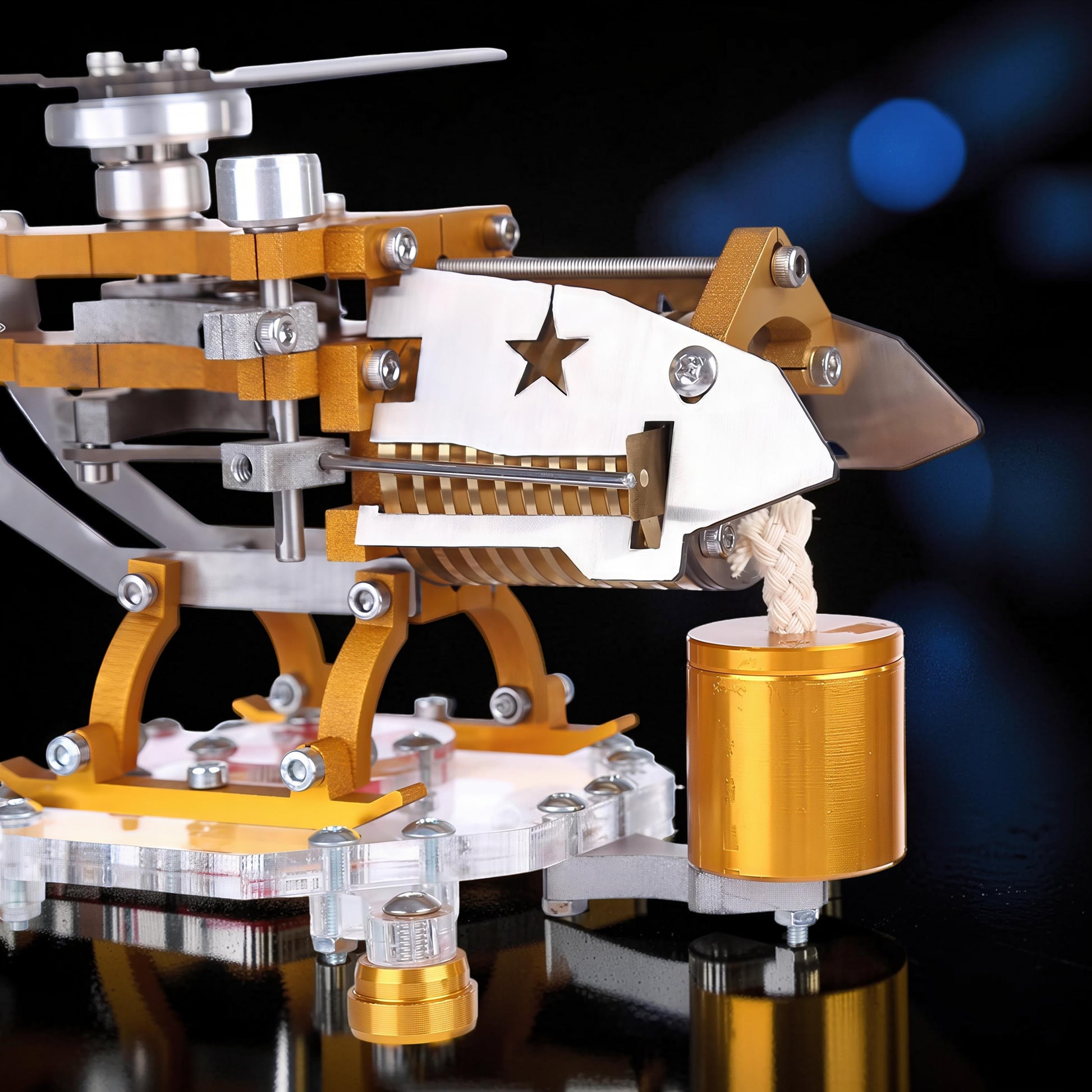 The Curious Mind Fire-Absorbing Stirling Helicopter Model features a metal construction with gold and silver accents, a star cutout, and a visible engine mechanism.