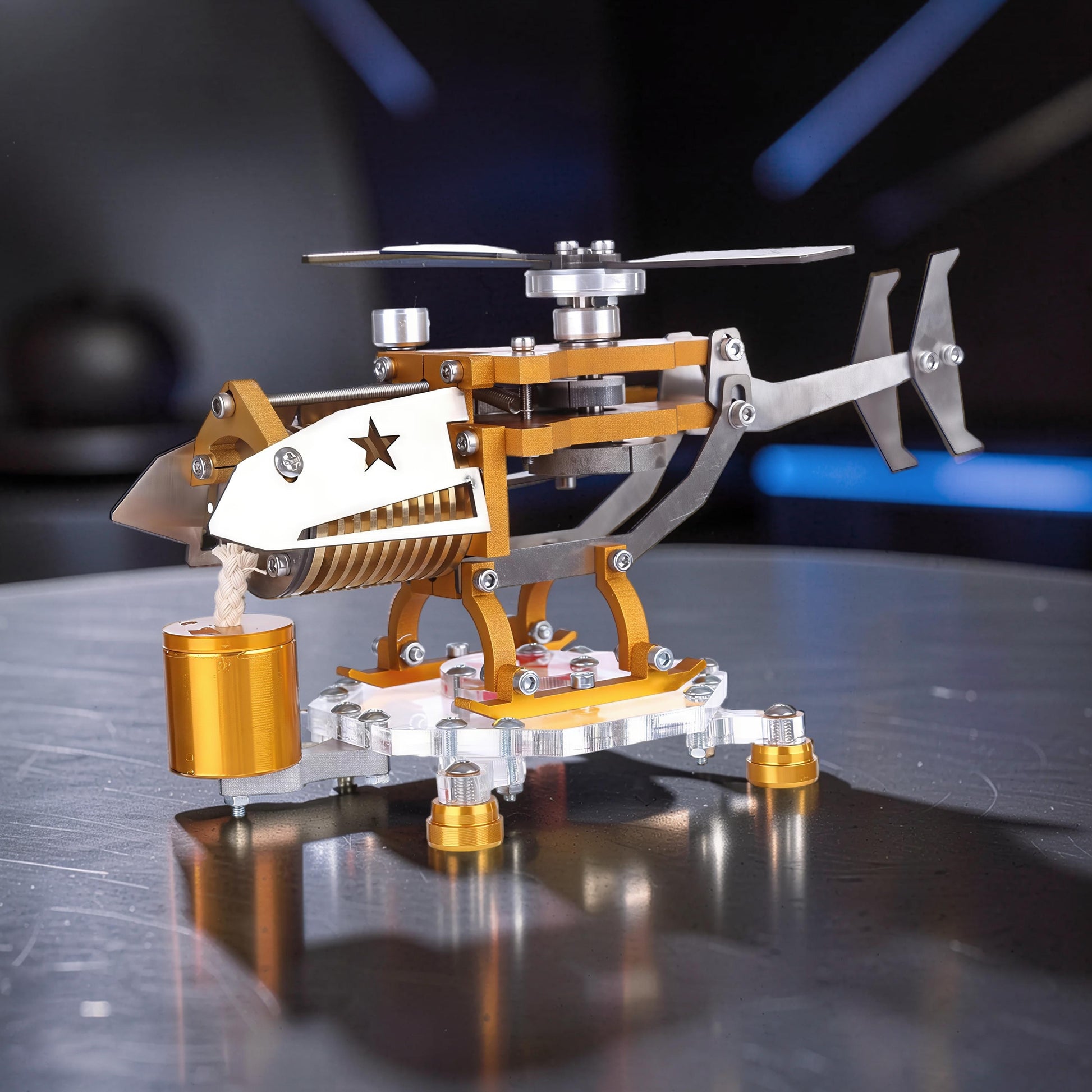 The Curious Mind Fire-Absorbing Stirling Helicopter Model, a detailed metal engine display with gold and silver accents, featuring a star cutout.