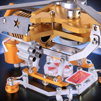 The Curious Mind Fire-Absorbing Stirling Helicopter Model, a detailed metal engine display with gold and silver accents, featuring a star-cutout rotor blade.