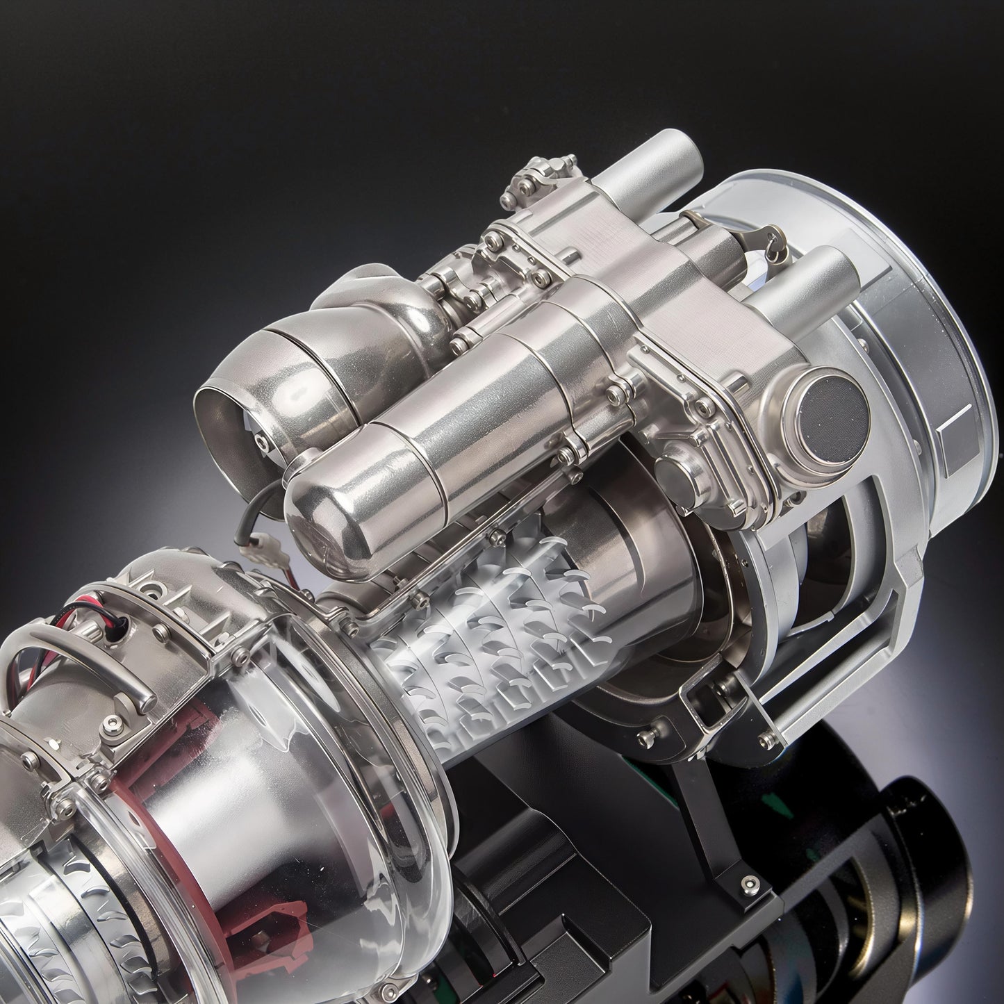 The Curious Mind T700 Turboshaft Engine DIY Kit, a detailed metal and clear plastic model with visible turbine blades and intricate mechanical components.