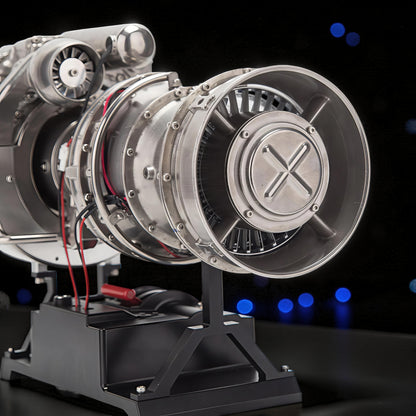The Curious Mind T700 Turboshaft Engine DIY Kit, a detailed metal model powerplant with intricate turbine blades and a display stand.