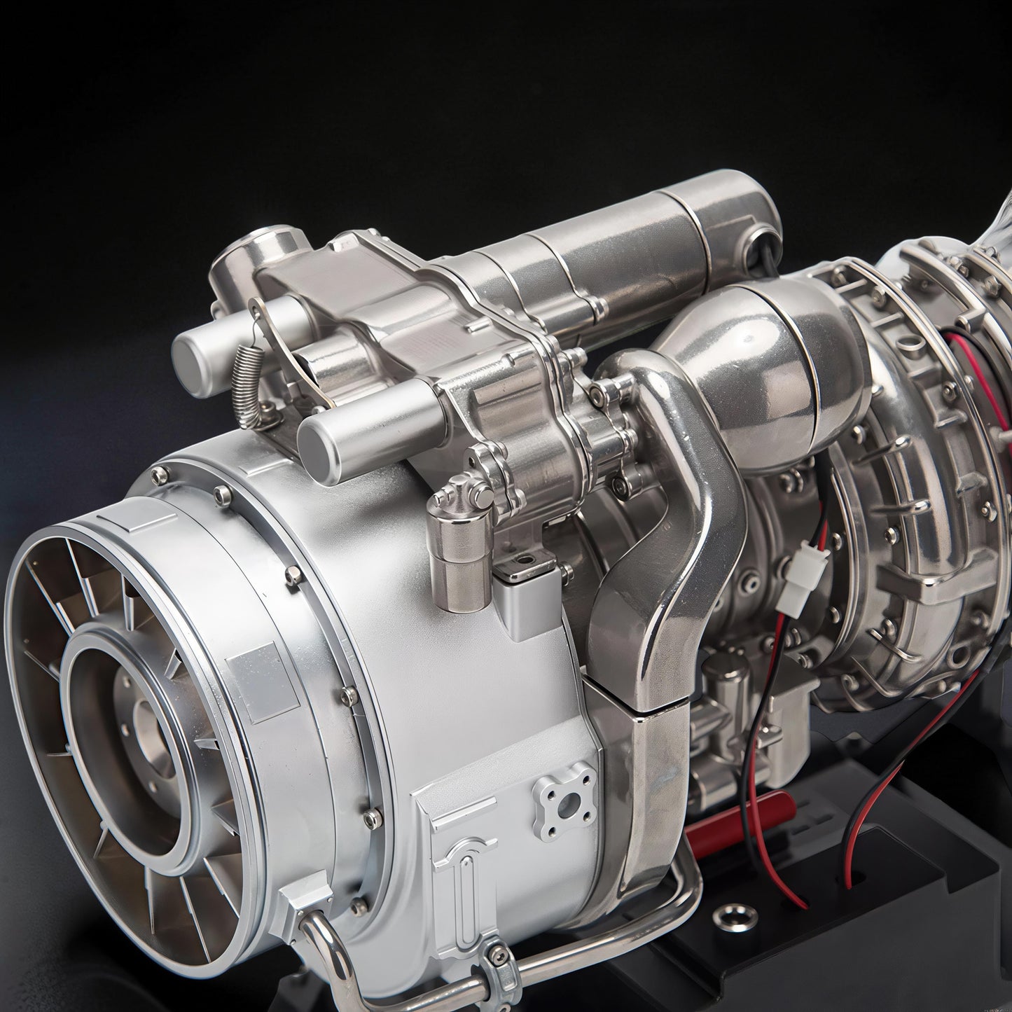 The Curious Mind T700 Turboshaft Engine DIY Kit, a detailed metal model powerplant with intricate components and red wiring.