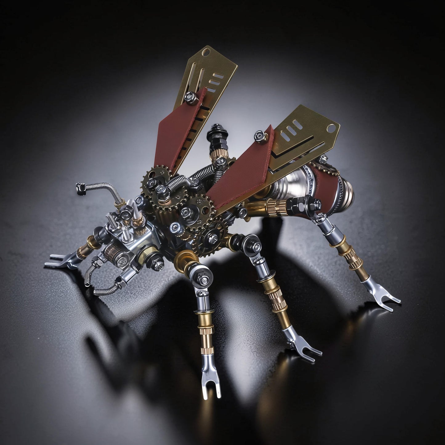 The Curious Mind Termite 3D metal model kit with brass, silver, and red accents. Intricate gears and mechanical details.