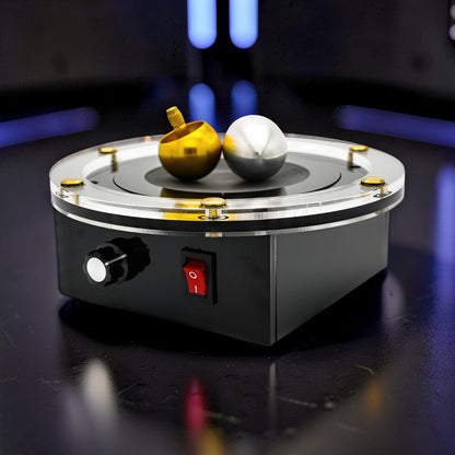 The Curious Mind Tesla Columbus Eggs Experiment Set with gold spinning top and silver egg on a black base with clear acrylic top.