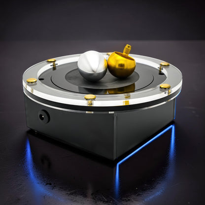 The Curious Mind Tesla Columbus Eggs Experiment Set with silver and gold spinning tops on a black base with blue LED lighting.