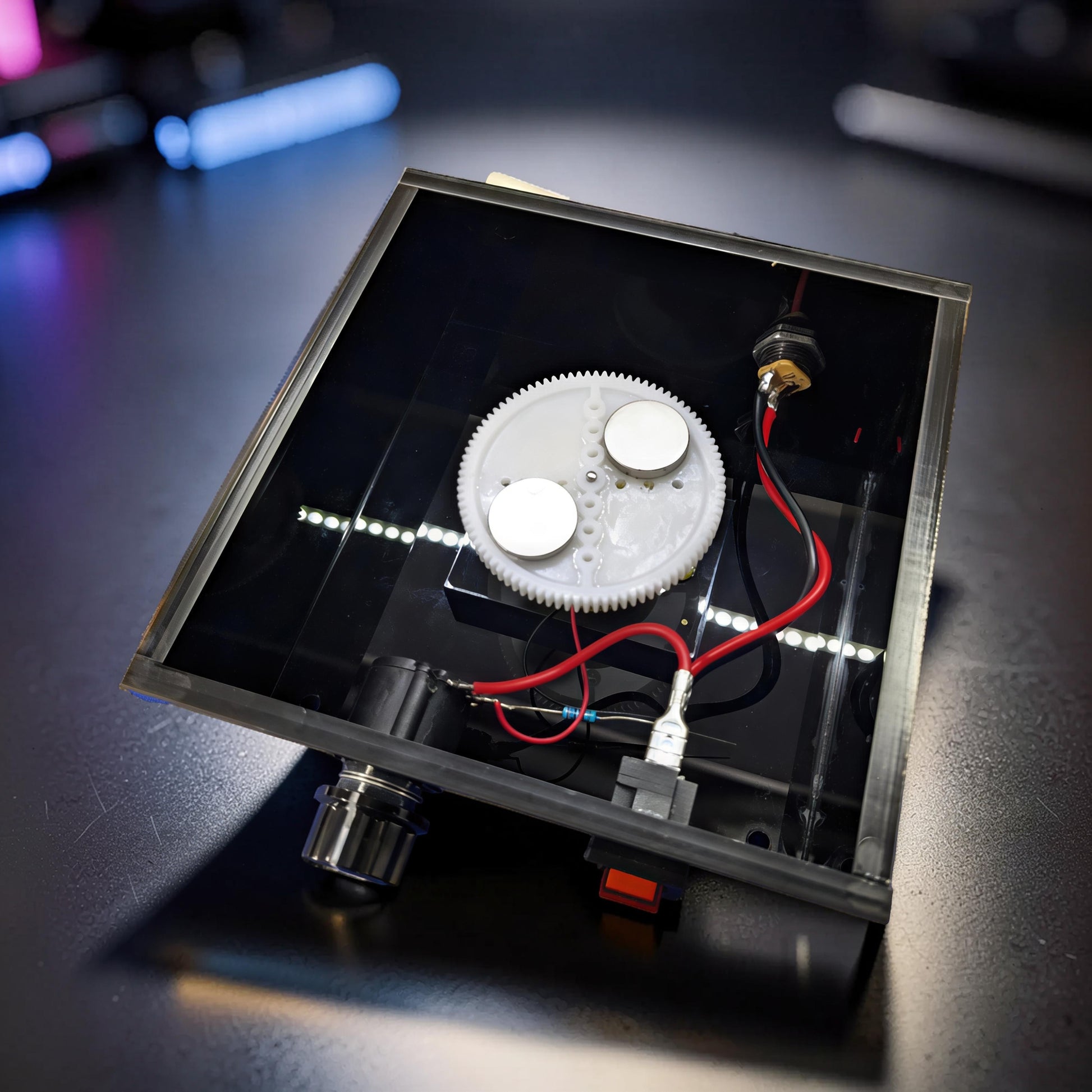 The Curious Mind Tesla Columbus Eggs Experiment Set features a spinning gear with magnets, wires, and LEDs on a black base.