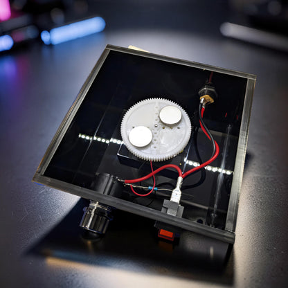 The Curious Mind Tesla Columbus Eggs Experiment Set features a spinning gear with magnets, wires, and LEDs on a black base.