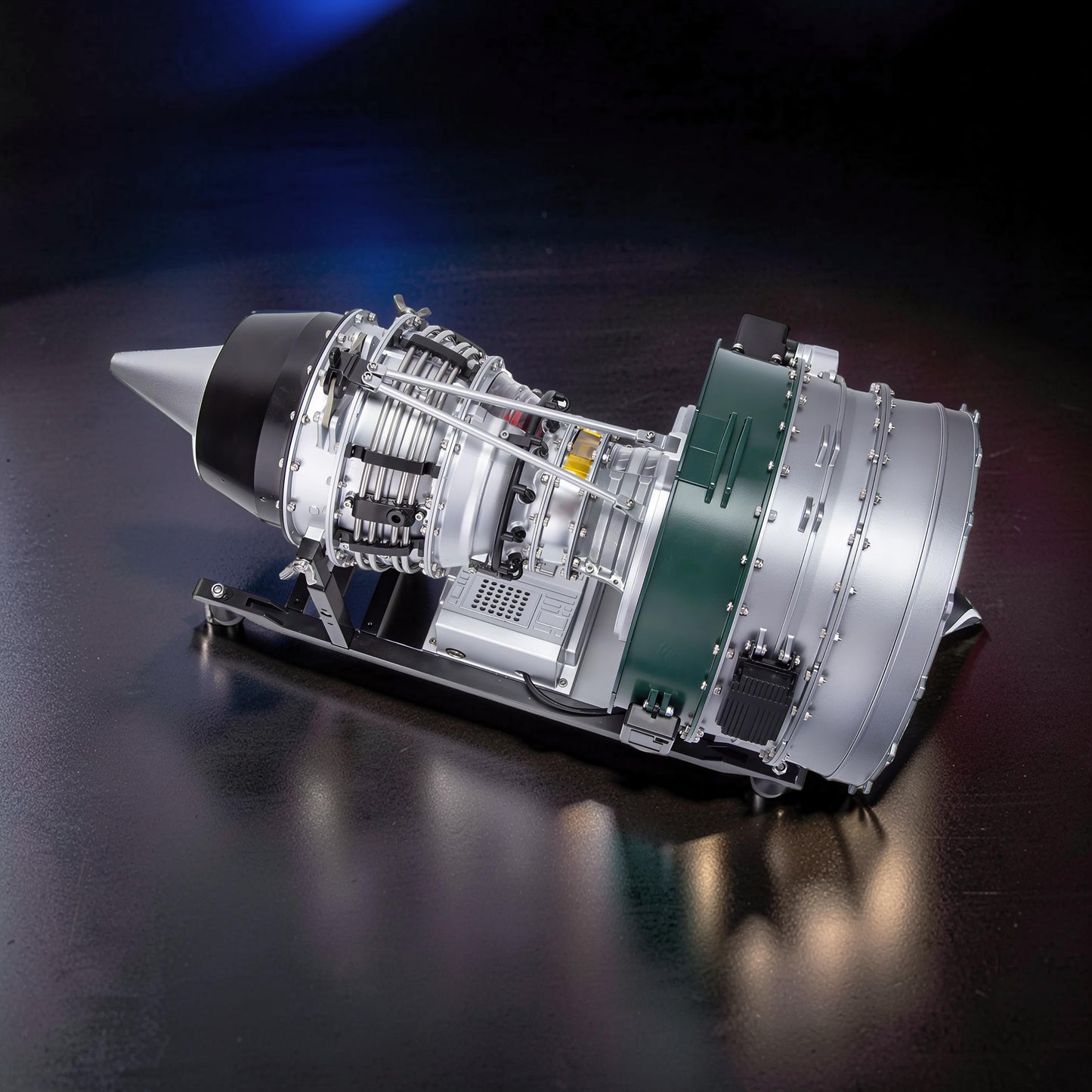 The Curious Mind Large Turbofan Engine DIY Kit is a detailed metal model with silver, black, and green accents, featuring intricate internal components and a display stand.