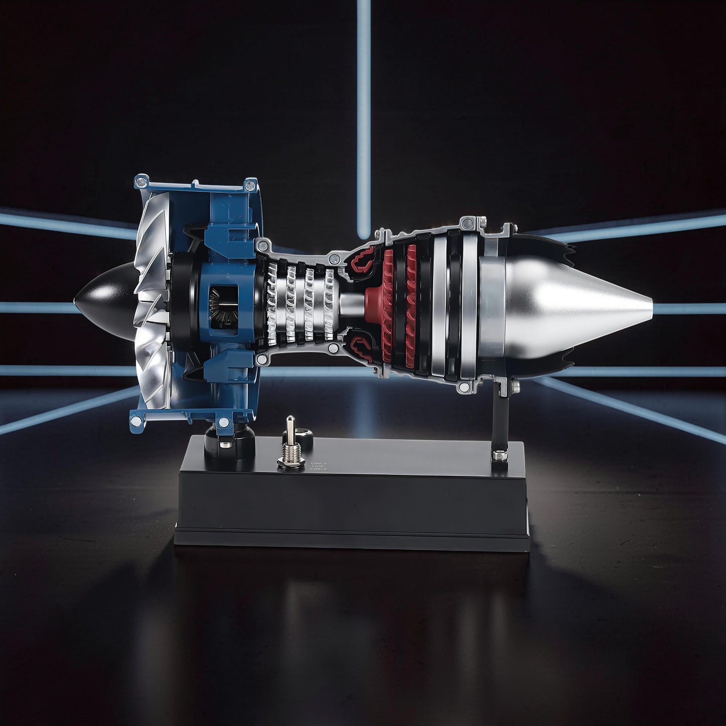 The Curious Mind Mini Turbofan Engine DIY Kit model, featuring intricate details of internal components, blue housing, silver fan blades, and red turbine elements, displayed on a black stand.