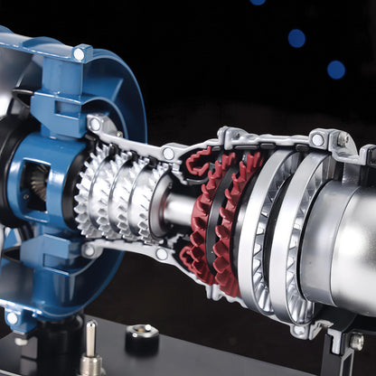 The Curious Mind Mini Turbofan Engine DIY Kit model, featuring intricate silver and red turbine blades and blue casing.
