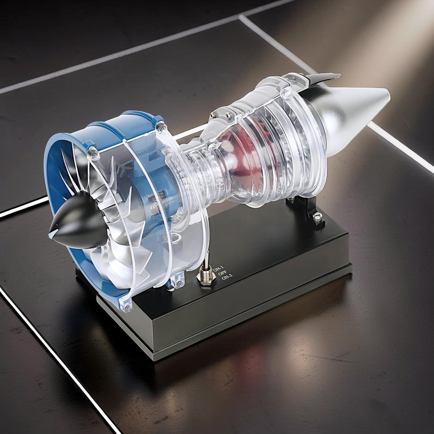 The Curious Mind mini turbofan engine DIY kit model, featuring clear casing, blue and silver accents, and a black display base.