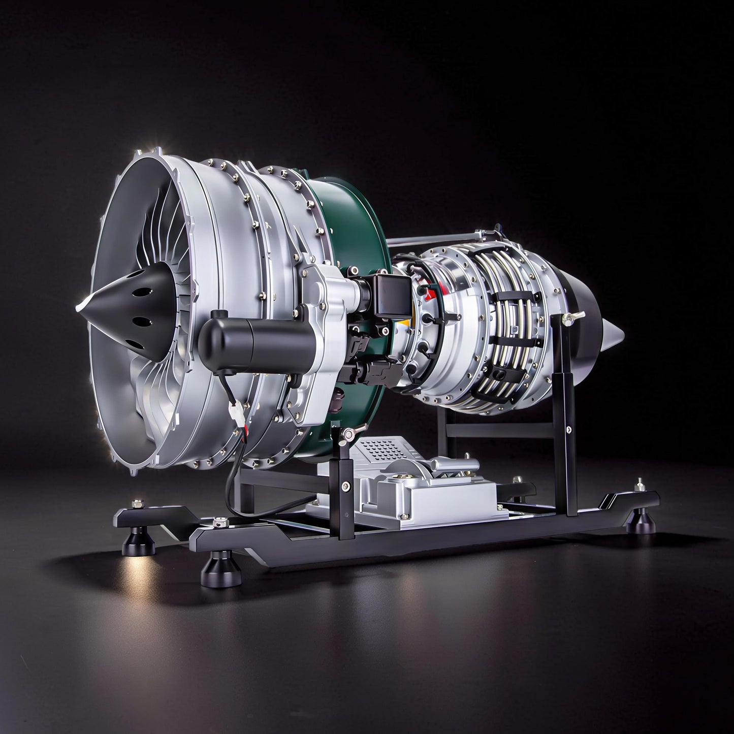 The Curious Mind Large Turbofan Engine DIY Kit, a detailed metal model with silver and green accents, displayed on a black stand.