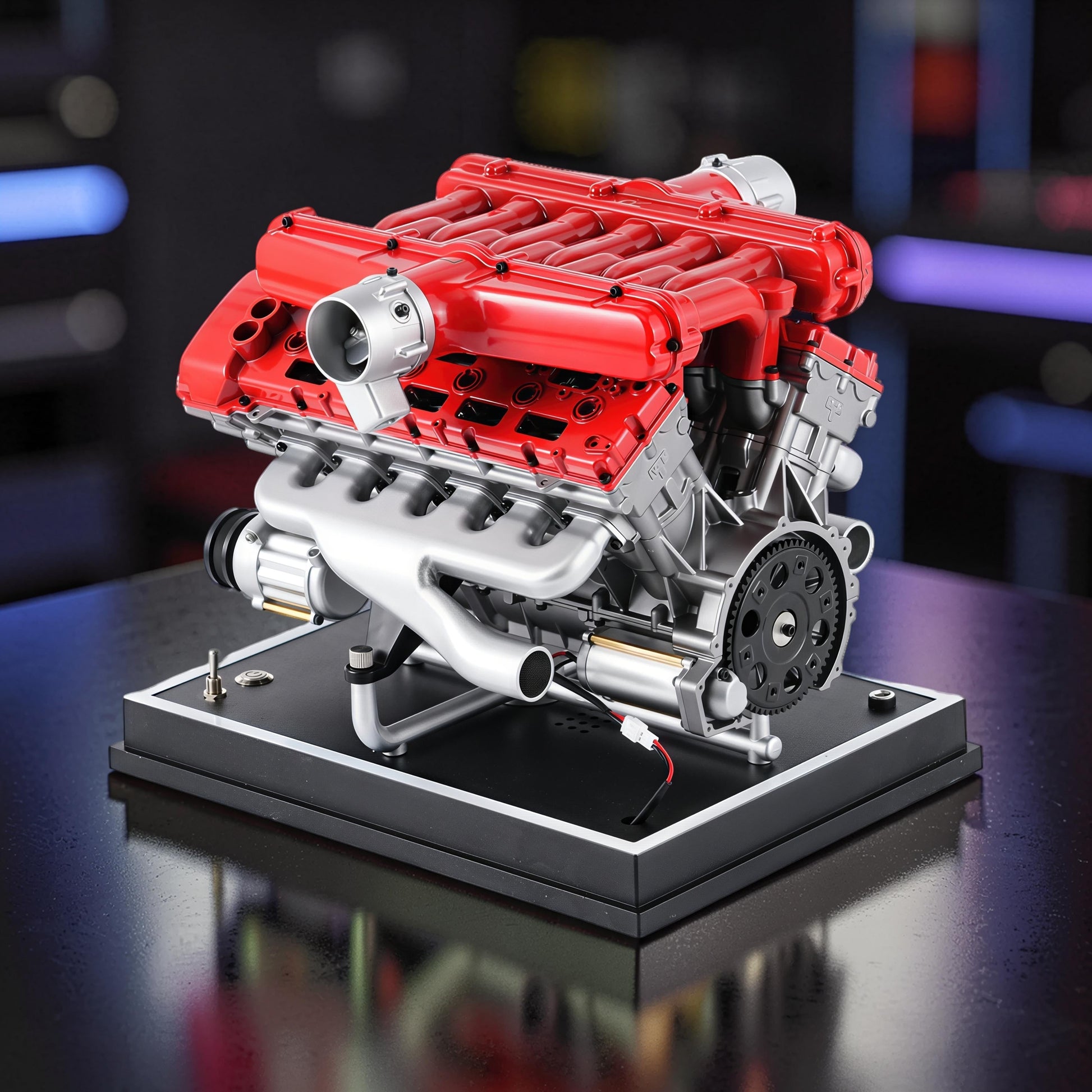 The Curious Mind V12 car engine DIY kit, a detailed metal mechanical model with red and silver components on a black display base.