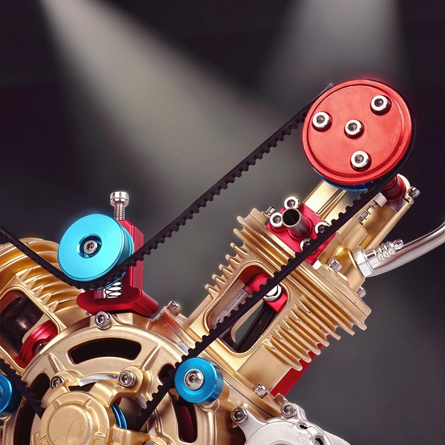 The Curious Mind Mini V2 Double-Cylinder Engine DIY Kit, a metal mechanical model with gold and red accents, featuring a belt-driven system.
