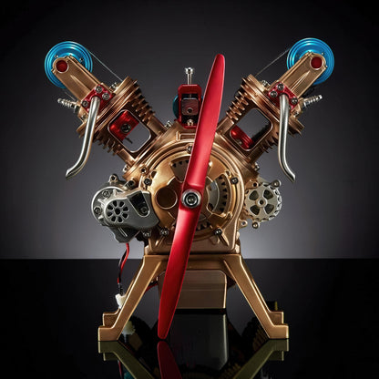 The Curious Mind Mini V2 Double-Cylinder Engine DIY Kit, a detailed metal mechanical model with a red propeller and gold-toned V-twin engine.