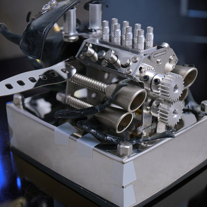 The Curious Mind Mechanical V8 Beetle display model made of alloy metal and resin, featuring intricate details like pistons, gears, and exhaust pipes.
