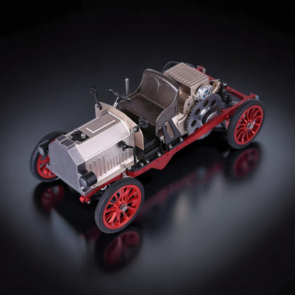 The Curious Mind Vintage Classic Car DIY Kit, a metal mechanical model with silver, red, and black accents. Features exposed gears and a detailed engine.