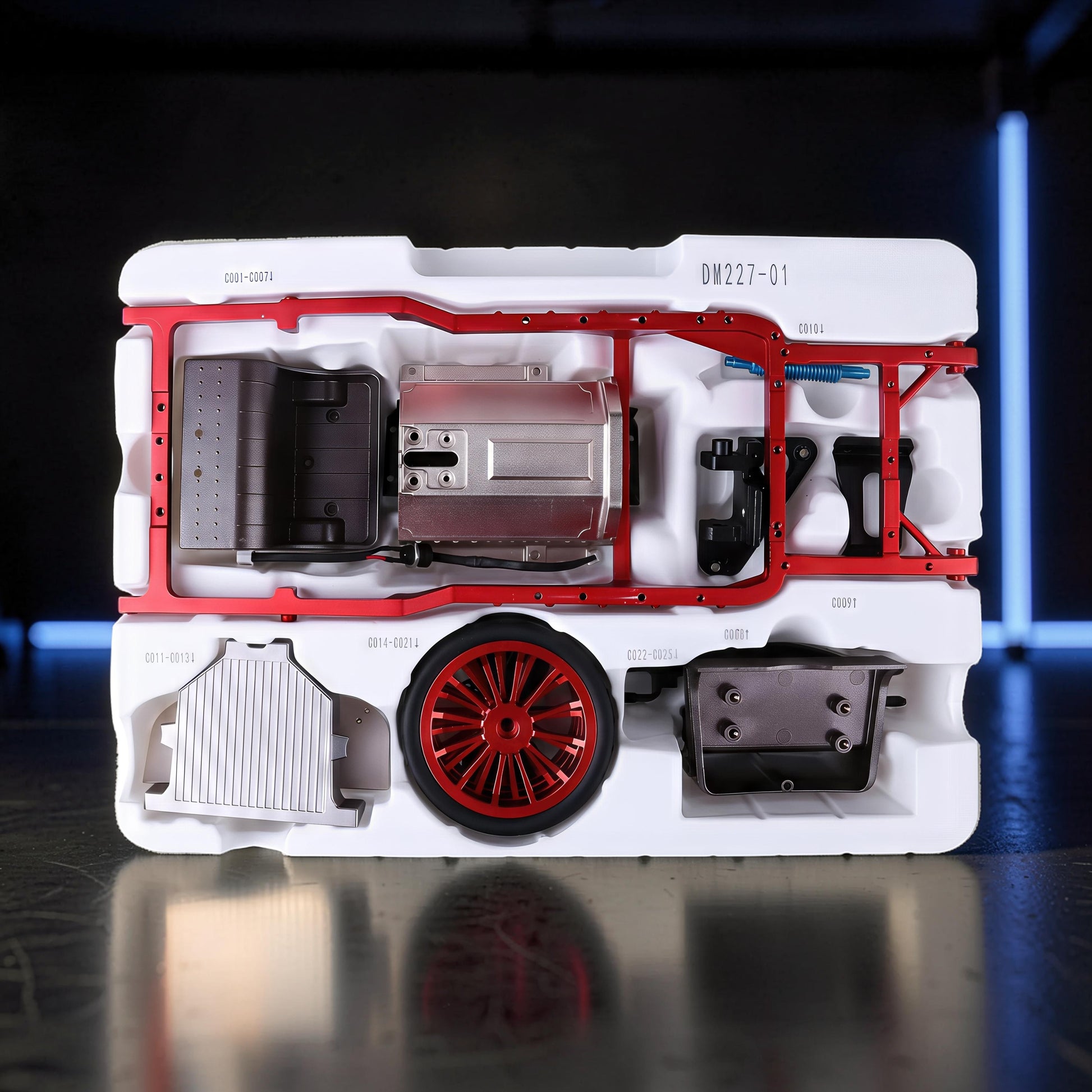 The Curious Mind vintage classic car DIY kit with metal engine, red wheel, and chassis parts in white packaging.