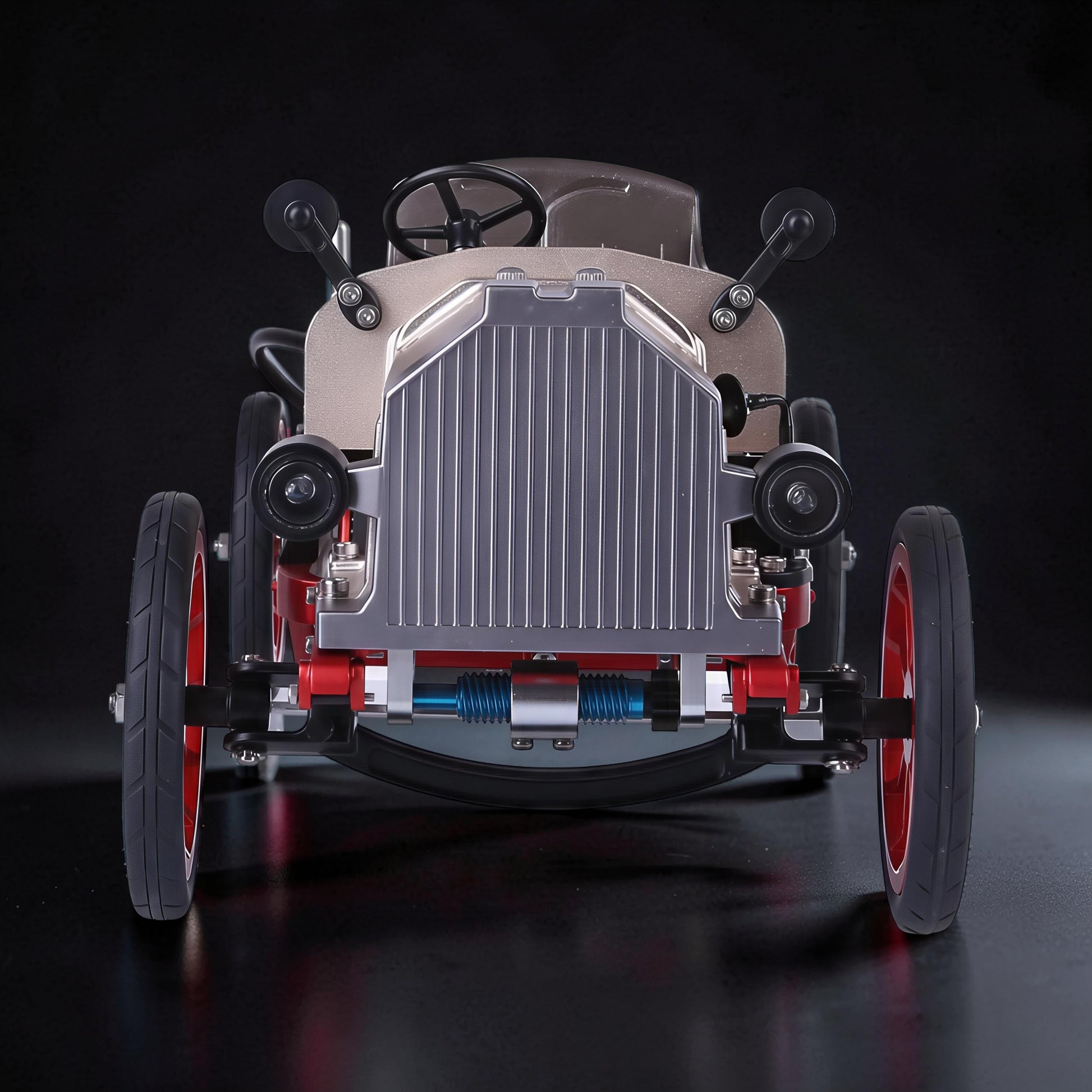 The Curious Mind Vintage Classic Car DIY Kit, a metal mechanical model with silver grille, tan body, red wheels, and black tires.