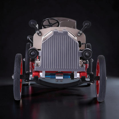 The Curious Mind Vintage Classic Car DIY Kit, a metal mechanical model with silver grille, tan body, red wheels, and black tires.
