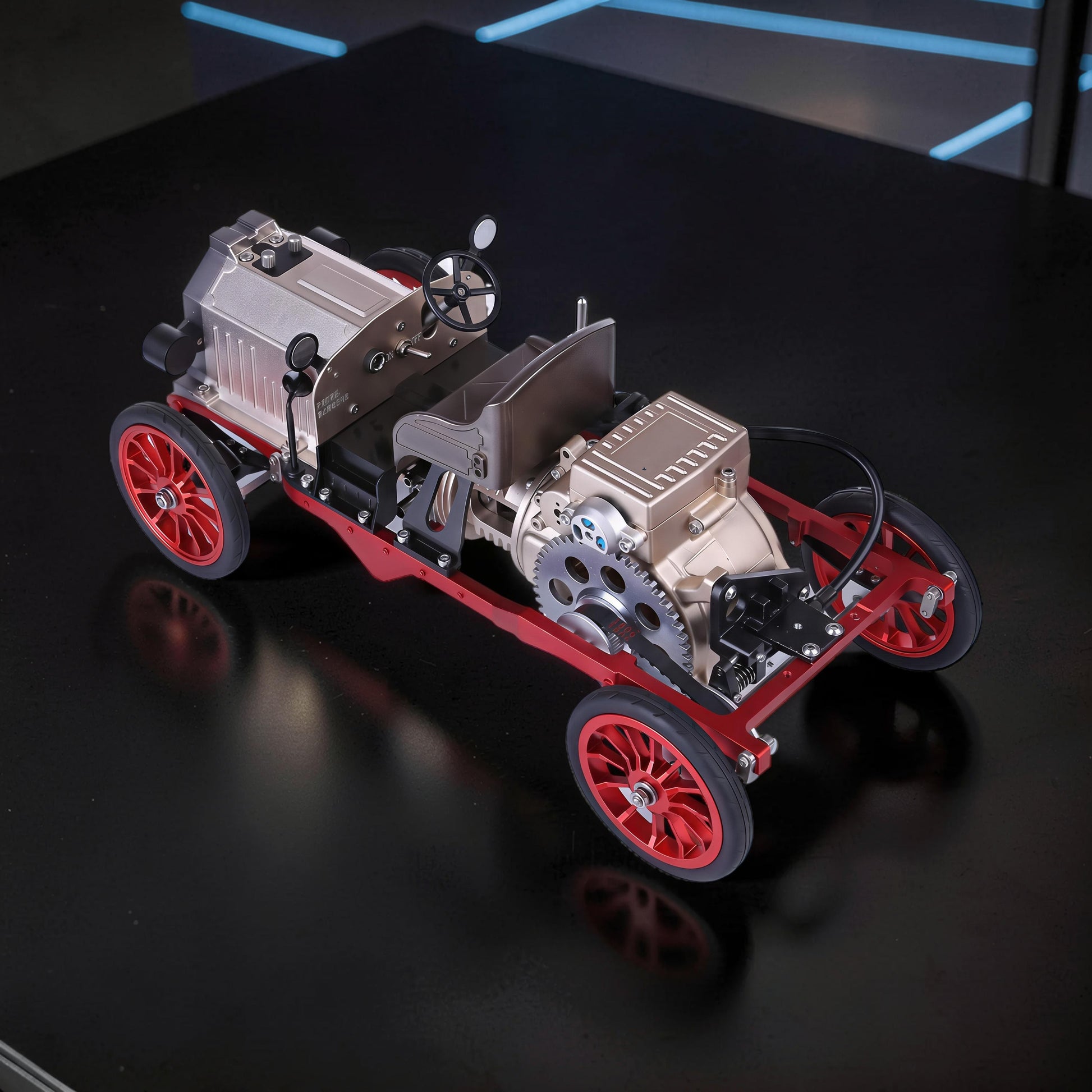 The Curious Mind vintage classic car DIY kit, a metal mechanical model with red wheels and intricate engine details.