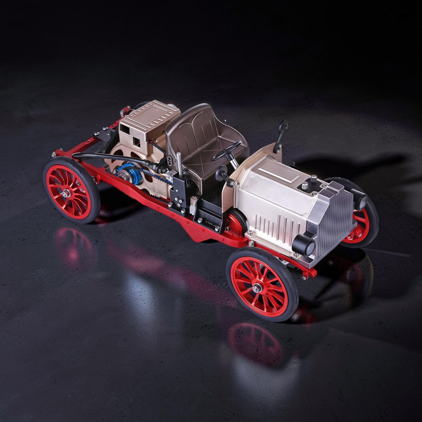 The Curious Mind vintage classic car DIY kit, a metal mechanical model with red wheels and frame, silver engine and body.