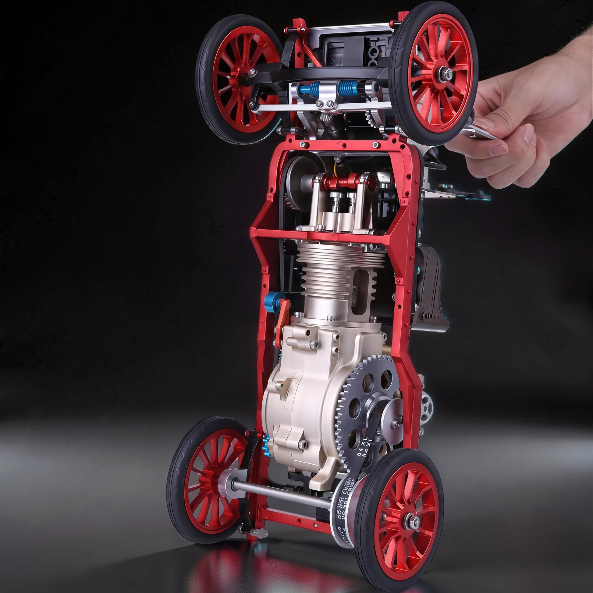The Curious Mind vintage classic car DIY kit, a red and silver metal mechanical model with visible engine and gears.