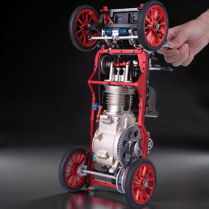 The Curious Mind vintage classic car DIY kit, a red and silver metal mechanical model with visible engine and gears.